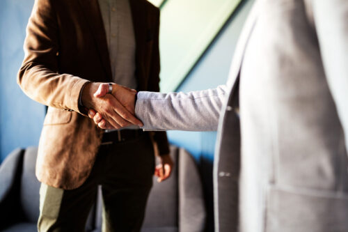 Two males hands showing shaking in agreement.